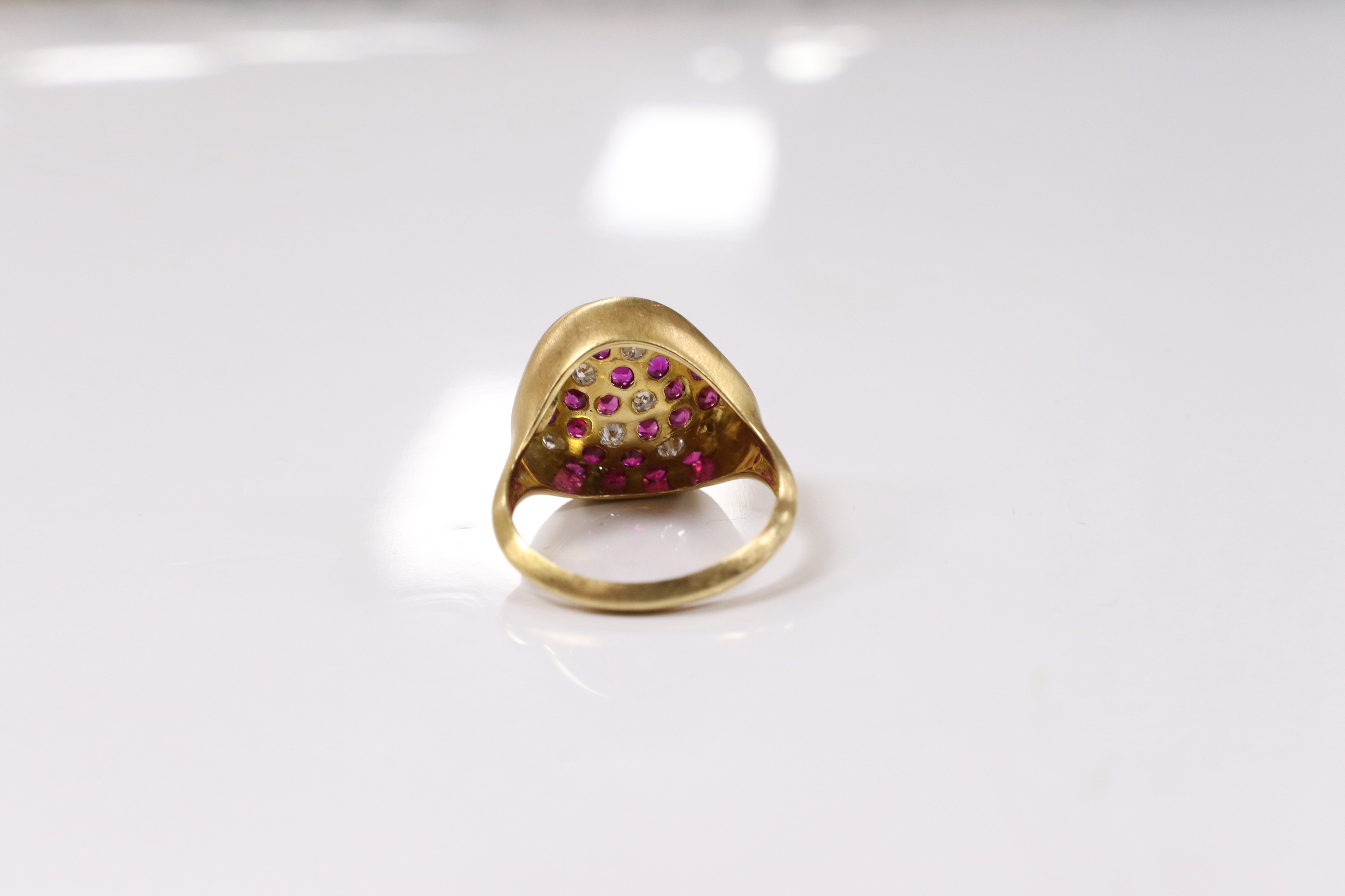 A modern 18k and pave set ruby and diamond set concave dress ring, size O, gross weight 5.4 grams. Condition - fair